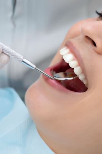 A dental check-up with a mouth mirror A dental check-up with a mouth mirror